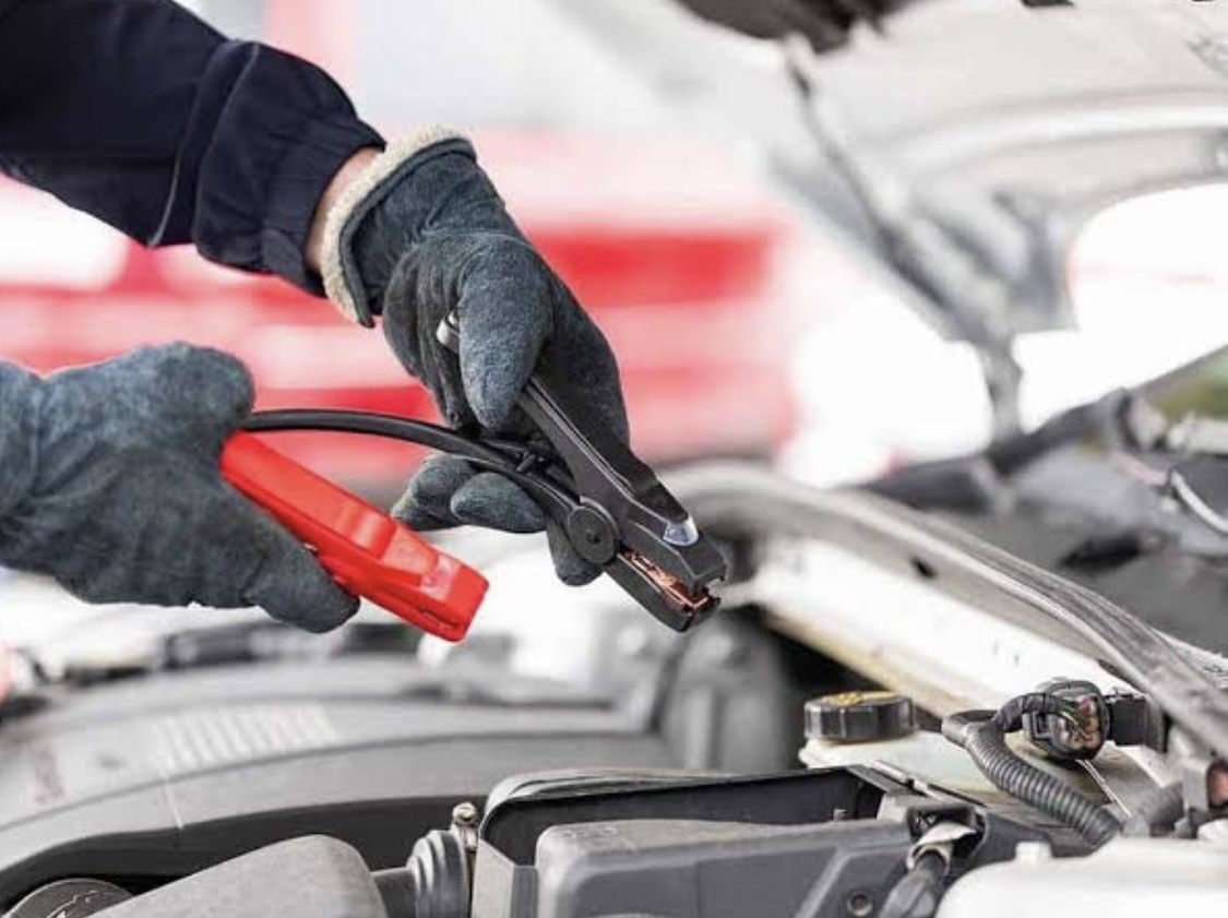 Jumper cables connected to a car battery